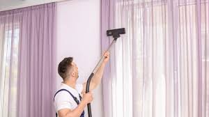 Carpet Cleaning Victoria Staff have curtain cleaning tool and cleaning the curtain.