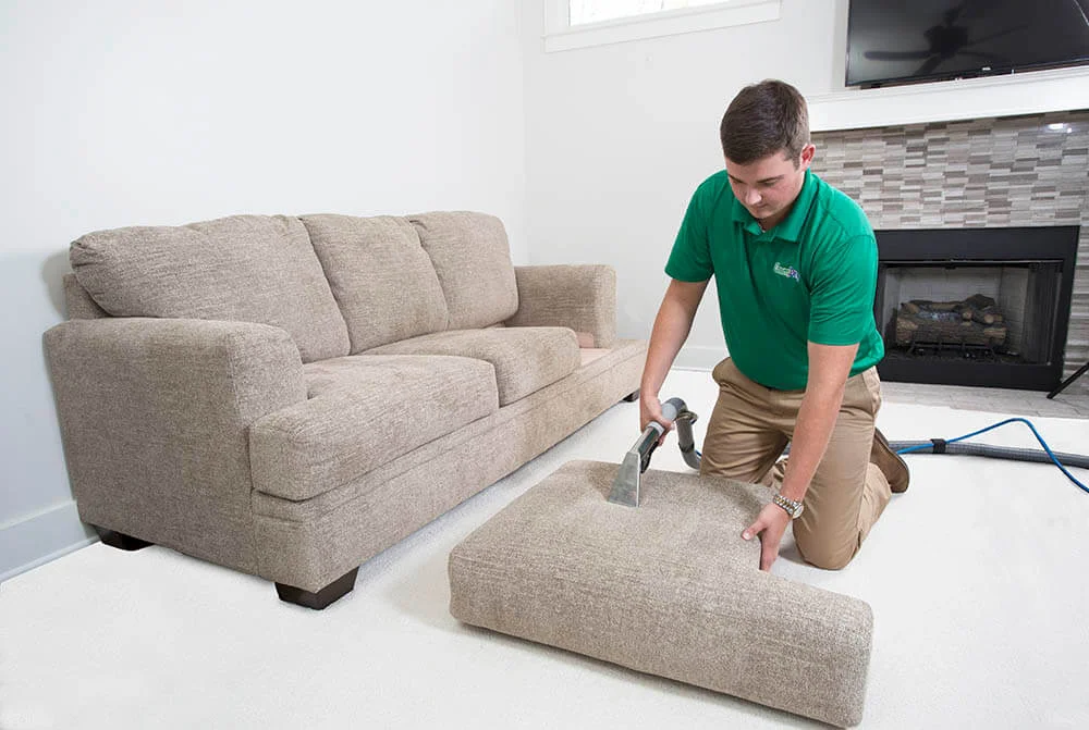 Carpet Cleaning Victoria Staff have cleaning tool and he is cleaning sofa with deep sofa cleaning process.